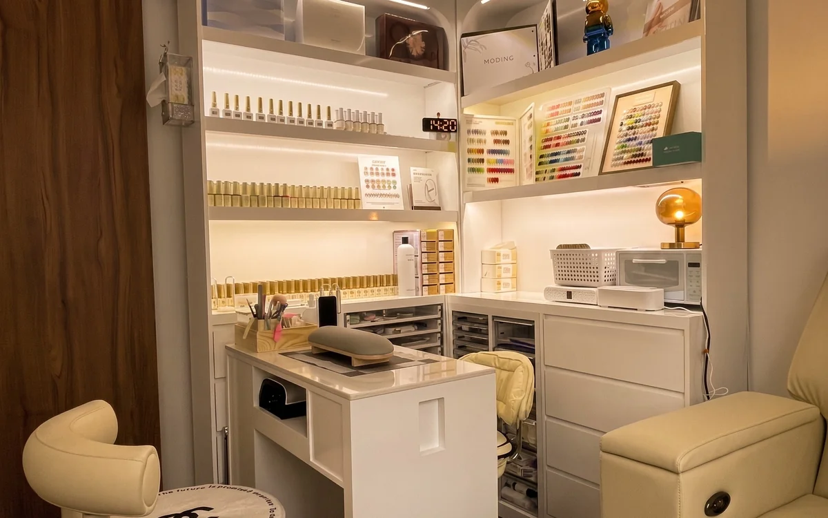 Nail station at the yeux by qun Hougang nail salon — gel polish shelves, colour charts and pedicure chair